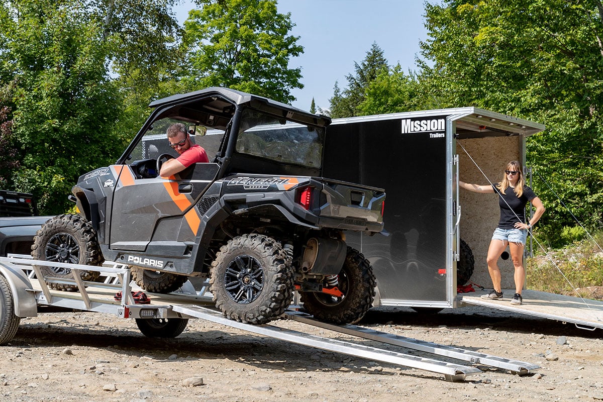 Unloading ATV from the open 83" aluminum ATV trailer from ALCOM