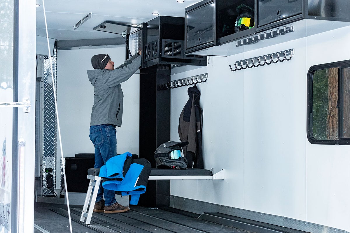 Interior of an Elevation All-Sport snow trailer showing benches and cabinets
