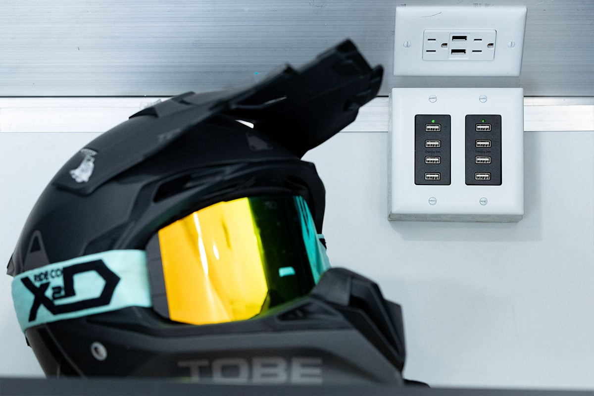 Helmet displayed inside an Elevation All-Sport trailer showing power/USB receptacles