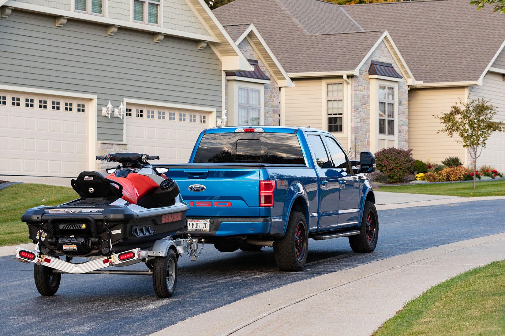 Triton aluminum Wave series trailer from ALCOM towed by a pickup truck