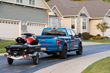 Triton aluminum Wave series trailer from ALCOM towed by a pickup truck
