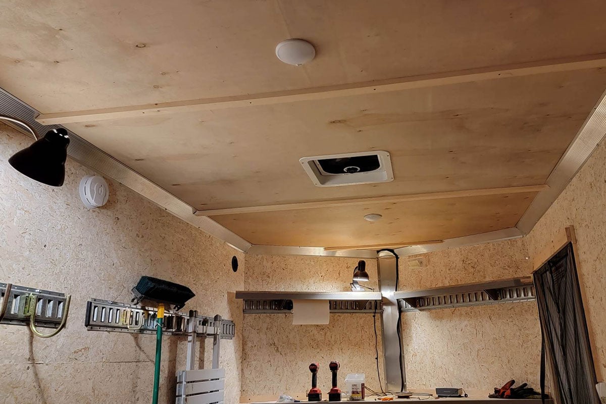 Inside Ted's UTV camping trailer with the insulated ceiling, lights, and wall tracks and hooks installed