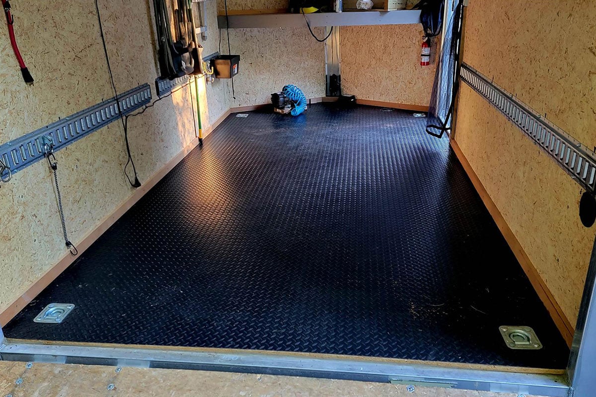 Ted added a rubber floor, corner tie-downs, and wall-mounted E-track inside his ALCOM aluminum trailer