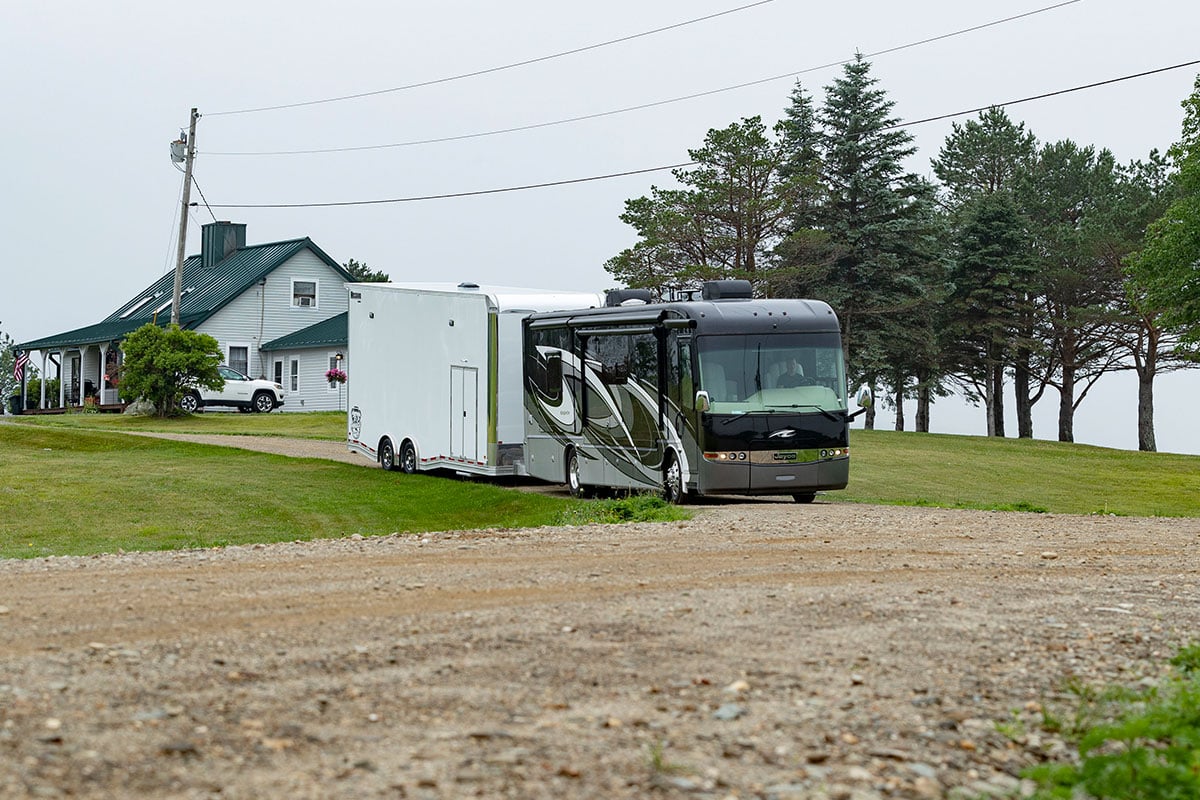 ALCOM's aluminum Pinnacle Stacker car hauler trailer towed behind an RV