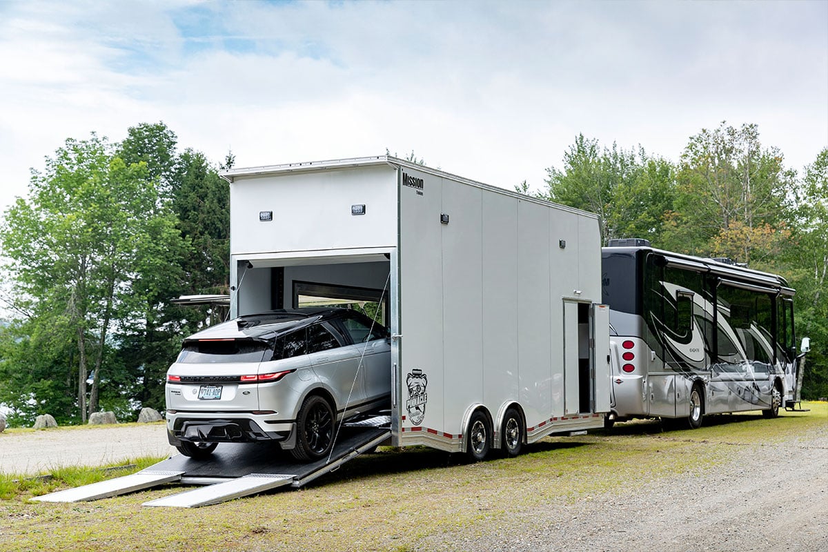 Loading a car into ALCOM's aluminum Pinnacle Stacker car hauler