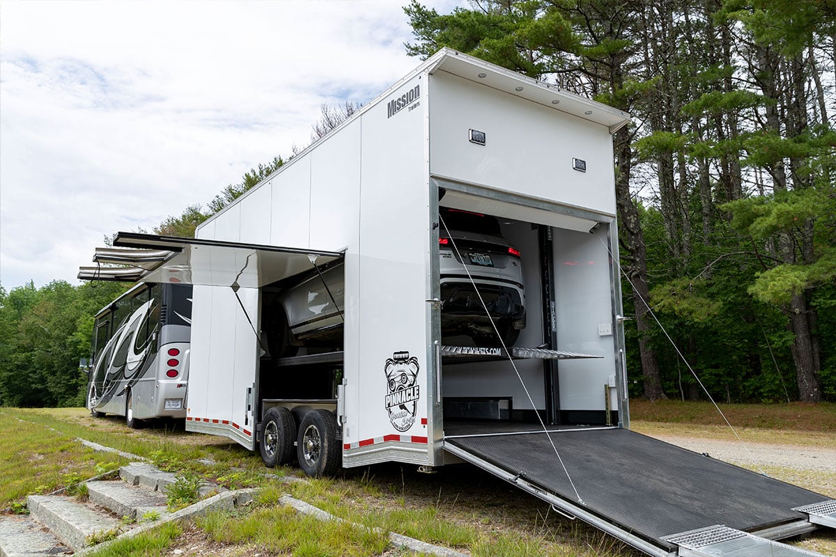Pinnacle Stacker aluminum car hauler from ALCOM loaded, hitched to an RV