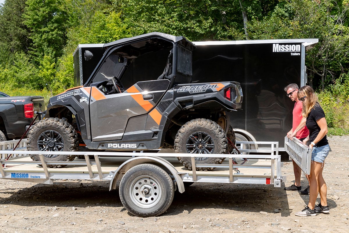 Open and enclosed aluminum UTV trailers from ALCOM ready to unload
