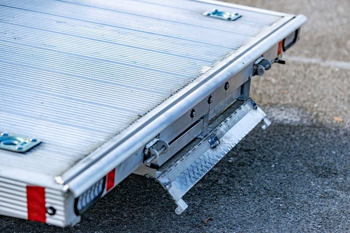 Extruded aluminum decking and recessed D-rings on an ALCOM open aluminum car trailer