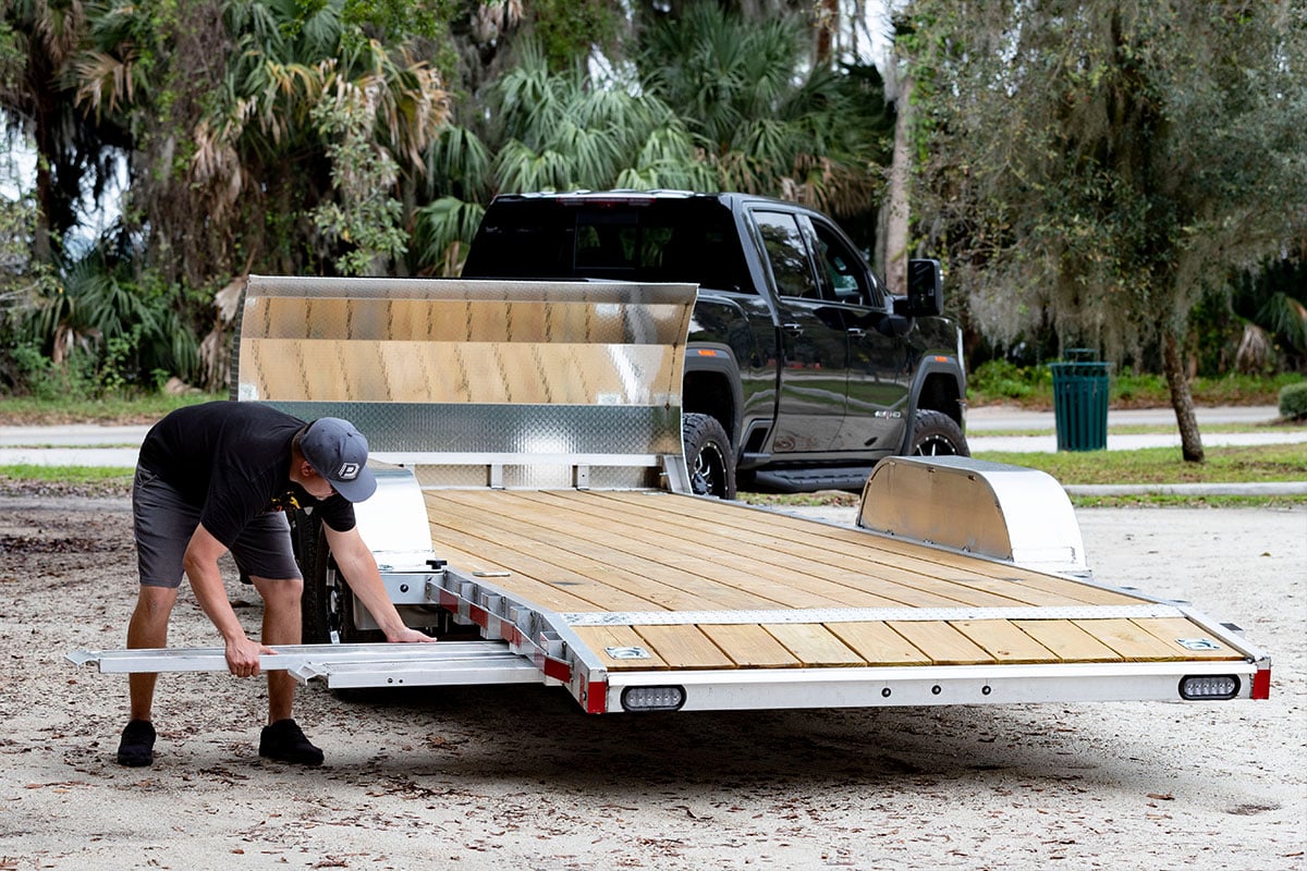 Stowable ramps on ALCOM open car haulers are easily stowed and removed