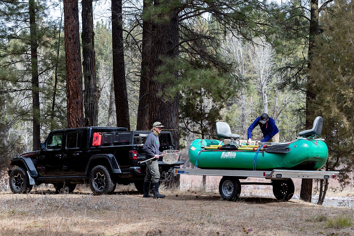 Two men getting ready to float fish with an inflatable raft in Montana
