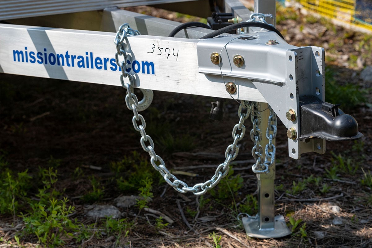 Jack and safety chains on an open aluminum utility trailer from ALCOM