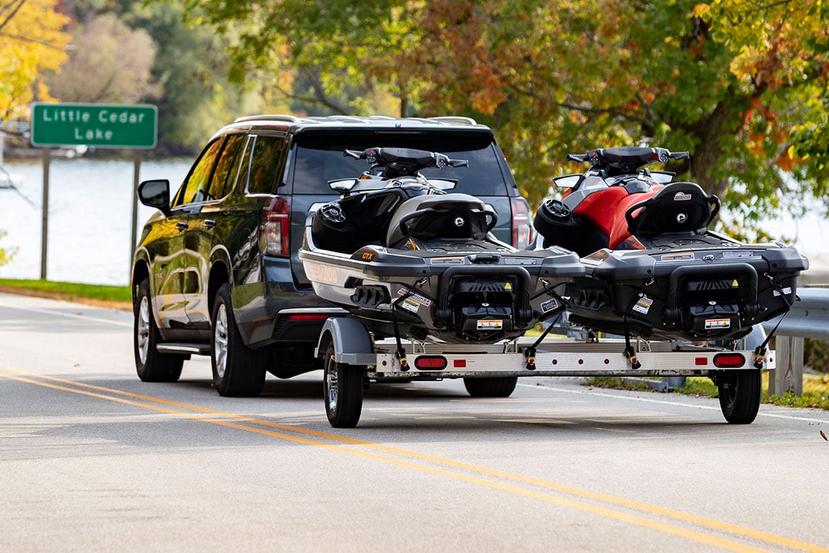 Triton personal watercraft trailer loaded with two PWC and towed by an SUV