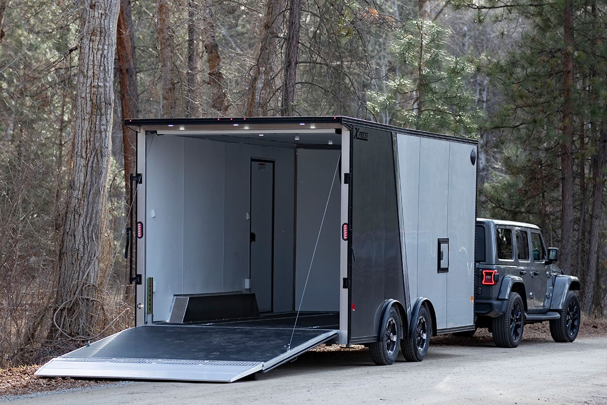 ALCOM enclosed aluminum trailer with interior and exterior lights visible