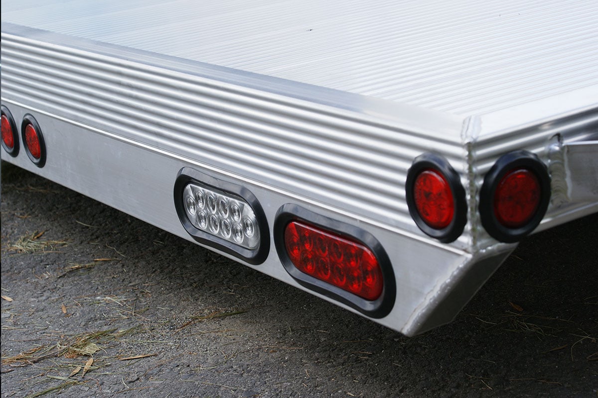 Recessed exterior brake, marker and directional lights on an open aluminum ALCOM trailer