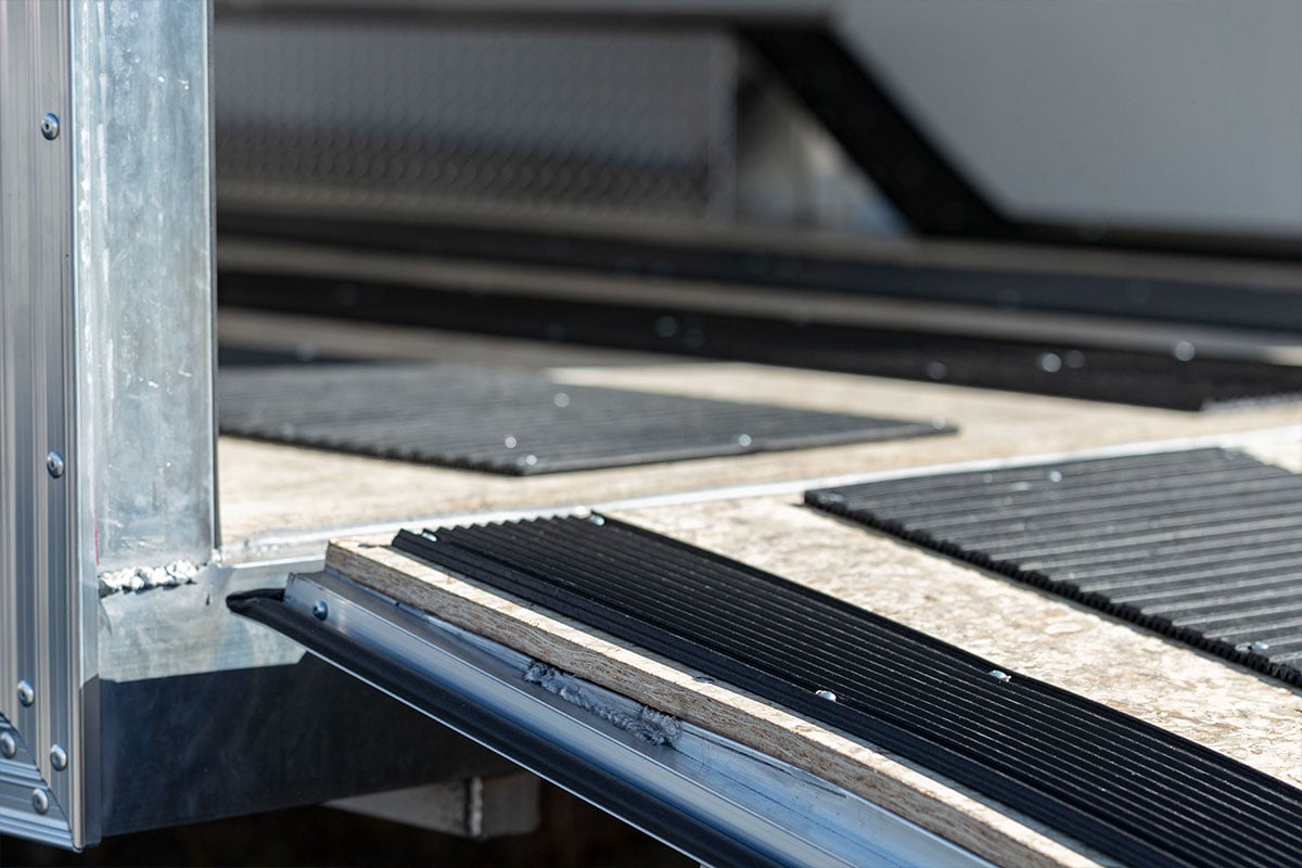 Ski guides and track mat in an enclosed aluminum snowmobile trailer.