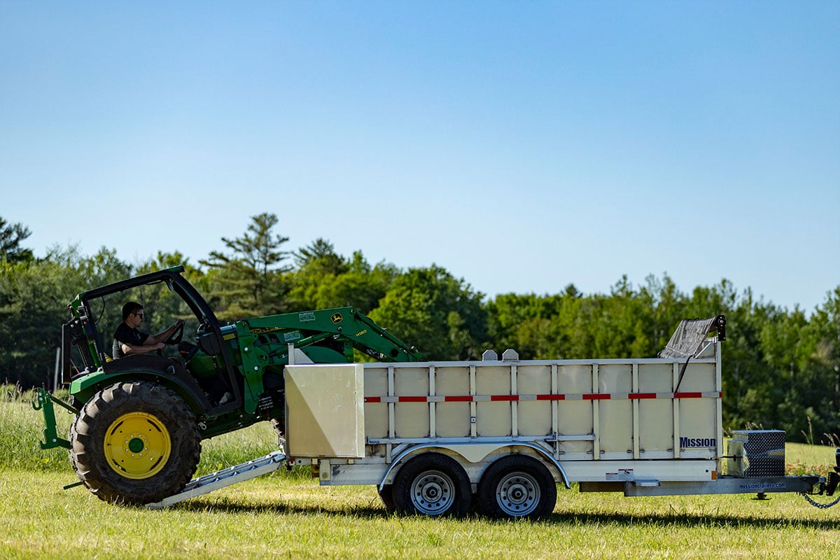 Driving a tractor into an ALCOM commercial dump trailer