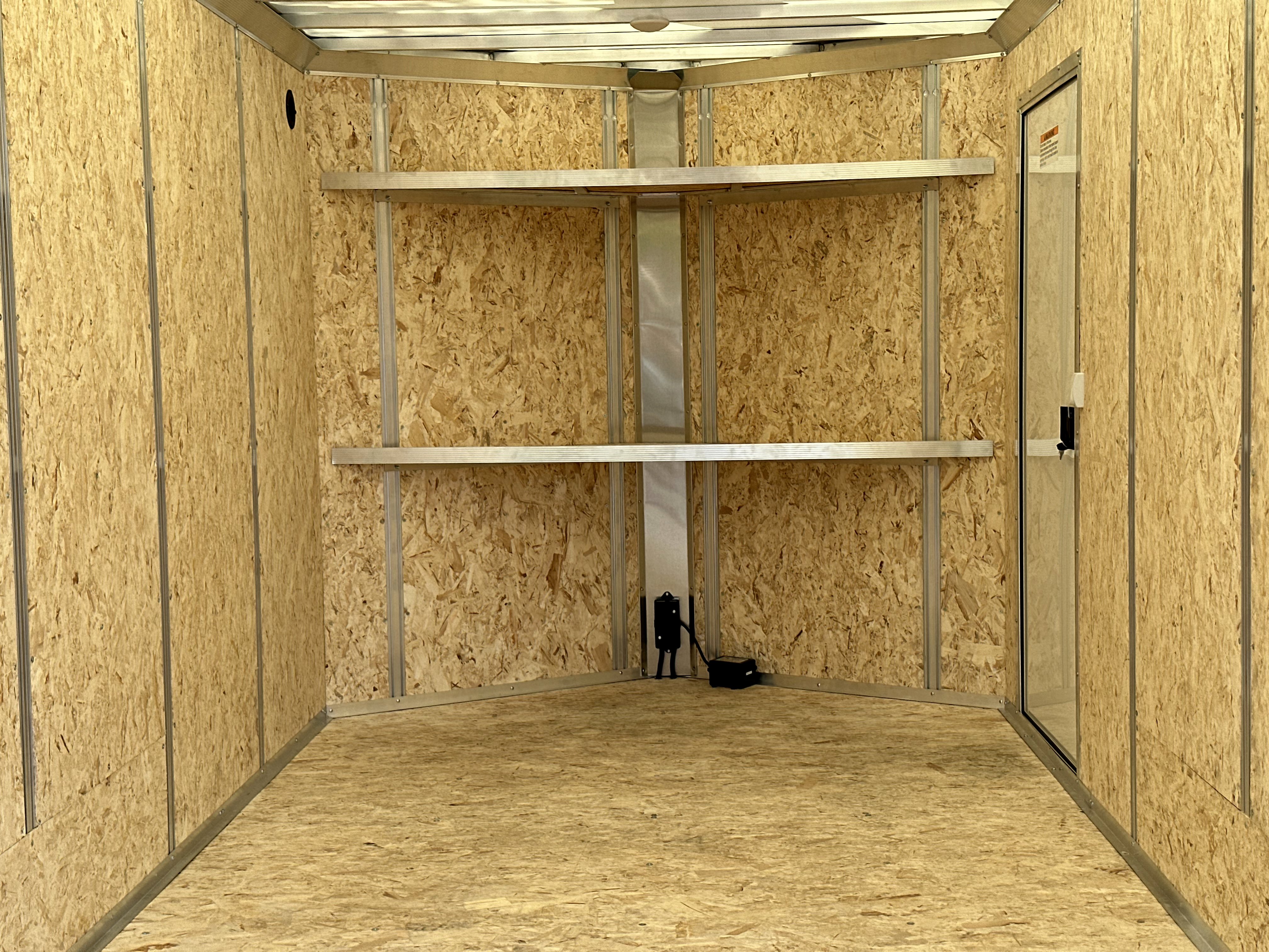 Interior of a cargo trailer with wall stud package and shelves installed