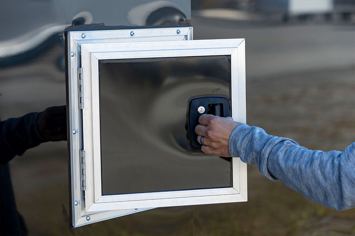 Side access fuel door on an enclosed ALCOM car hauler