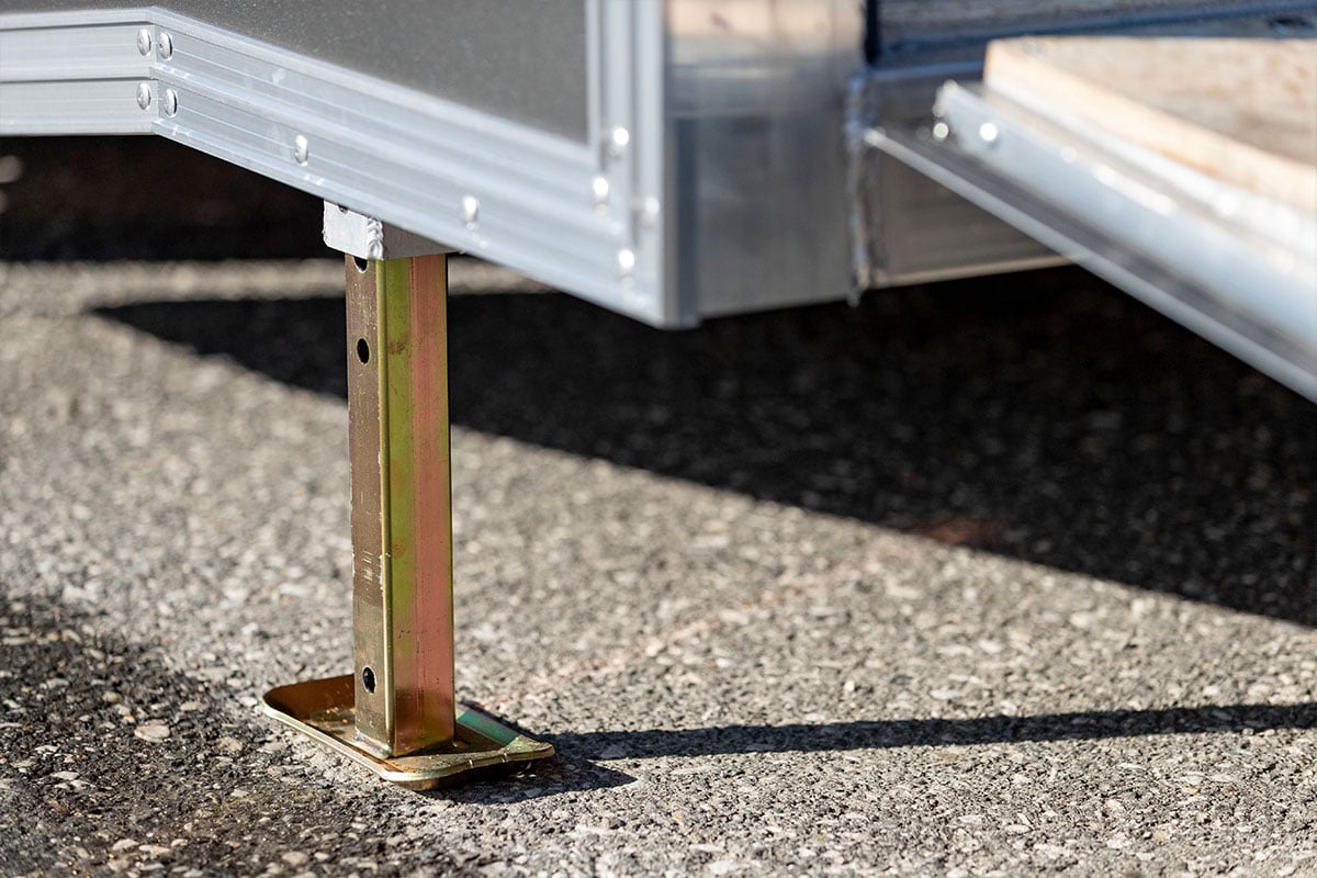 Rear corner jacks on enclosed ALCOM car hauler