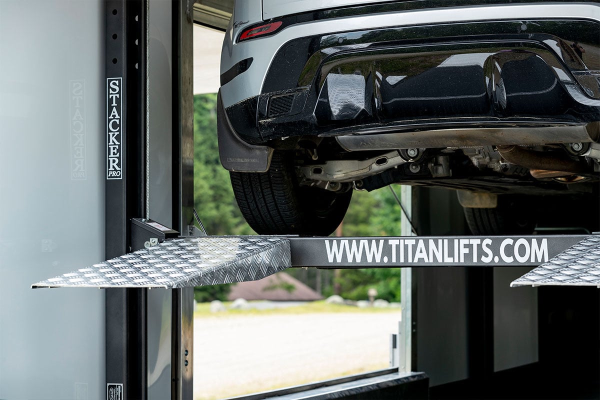 Titan lift inside an ALCOM enclosed Pinnacle Stacker car hauler