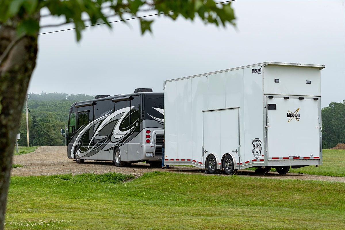 Pinnacle Stacker enclosed car hauler by ALCOM pulled by an RV