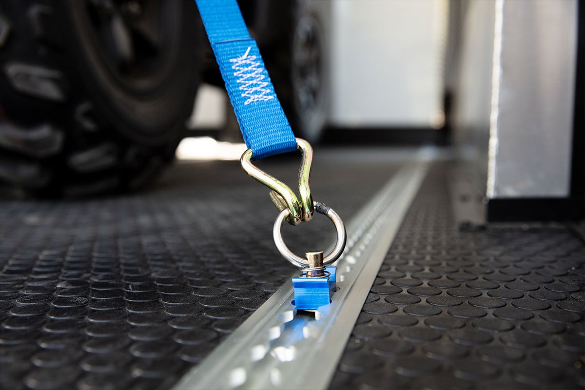 Airline track used with a tie down strap in an ALCOM enclosed aluminum trailer