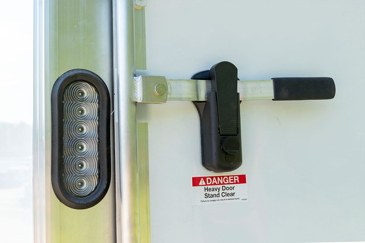 Locking bar with hasp closure on enclosed ALCOM aluminum trailer 