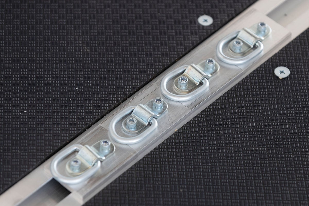 Recessed slide track and D-rings with quad ply flooring in ALCOM aluminum trailer