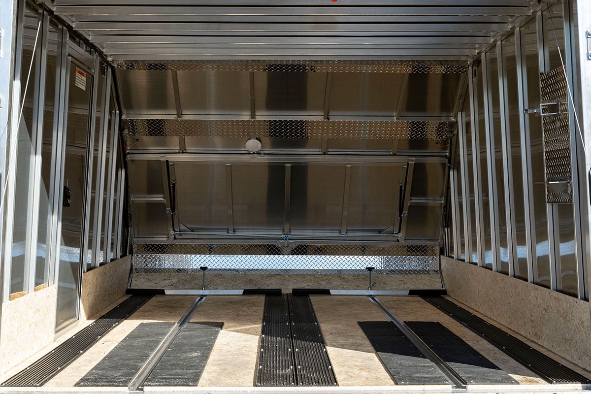 Interior of a crossover snow trailer with track mats, ski guides, tie-down bars and recessed slide track