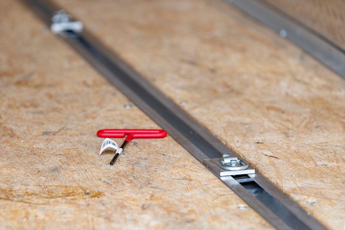 Slide track installed in water resistant decking in an ALCOM enclosed aluminum trailer