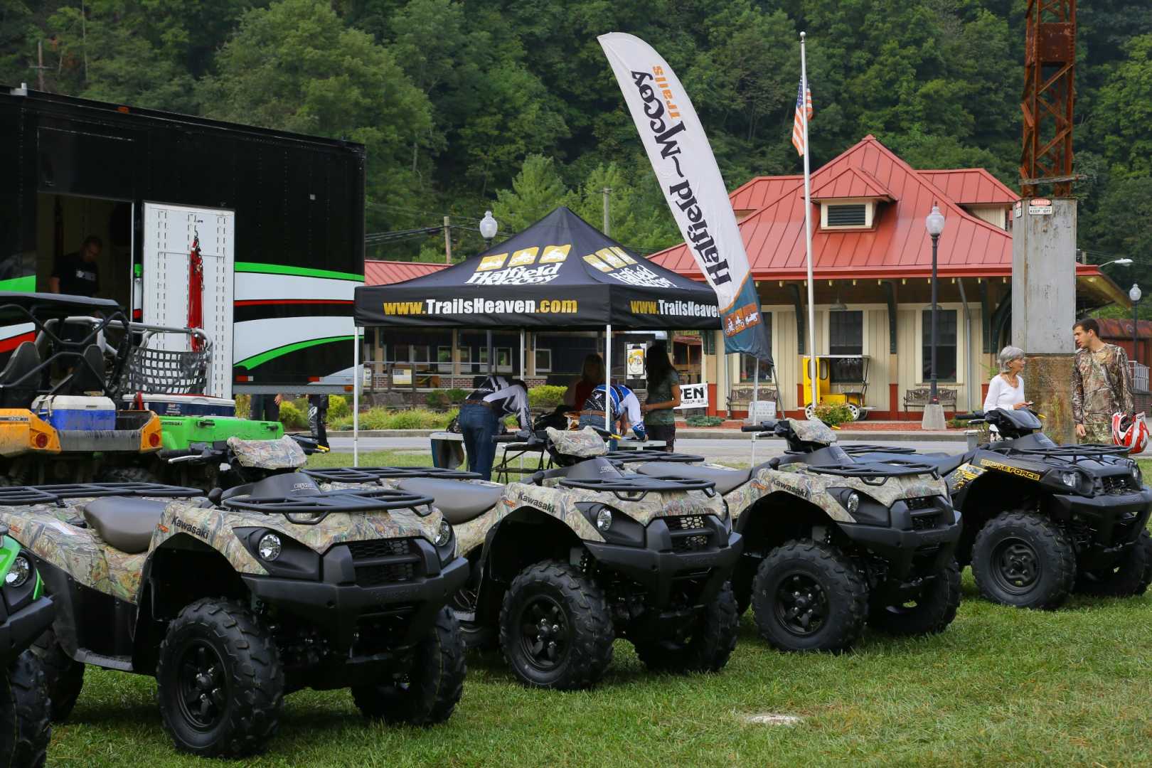 A Trails Heaven/Hatfield-McCoy Trails Network welcome center with banners and ATVs 