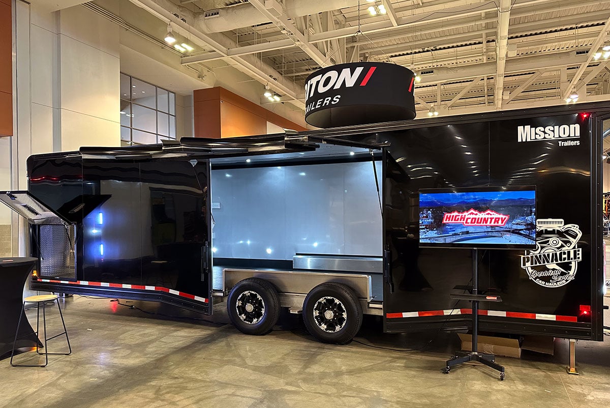 An enclosed aluminum car hauler set up at ALCOM's NATDA Trailer Show exhibition