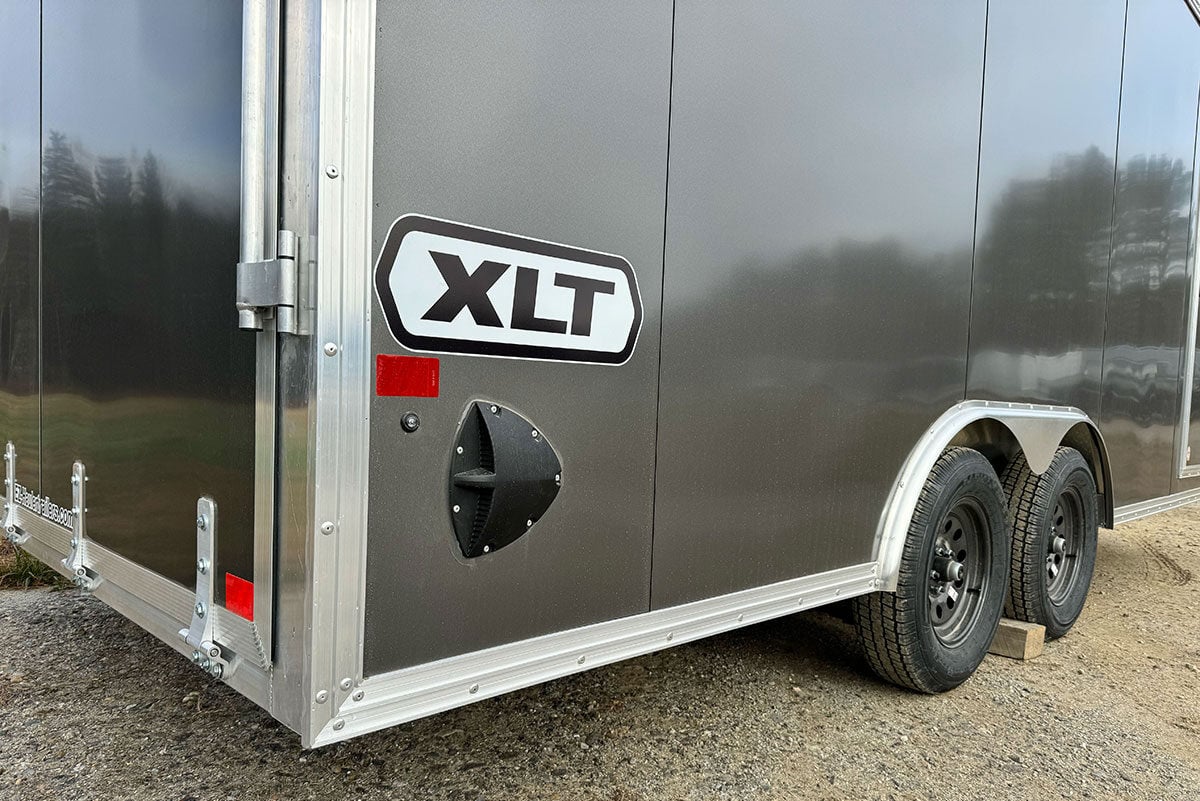 XLT Pro car hauler side photo showing trim, rear door, side panels, fender, logo and vent