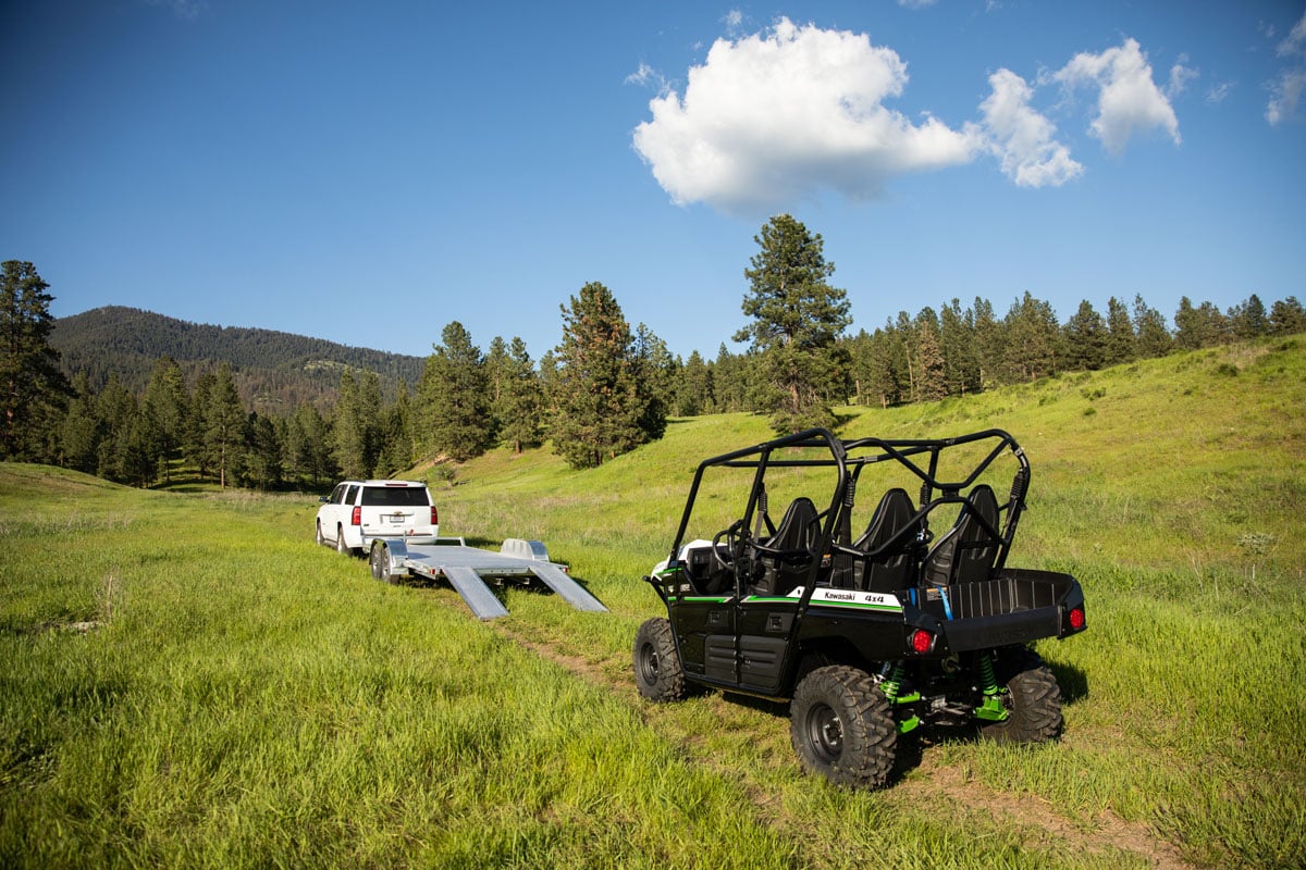 alcom-aluminum-trailer-towed-by-suv-with-side-by-side-in-field-1