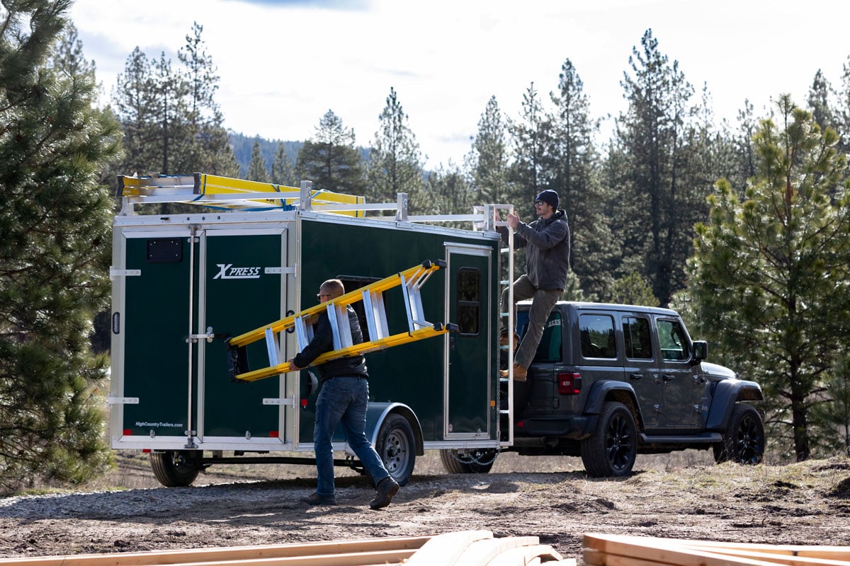 5' wide contractor trailer towed by a Jeep at a jobsite