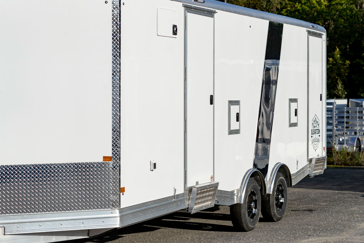 An Elevation All-Sport enclosed aluminum trailer with multiple side access doors w/step and fuel doors