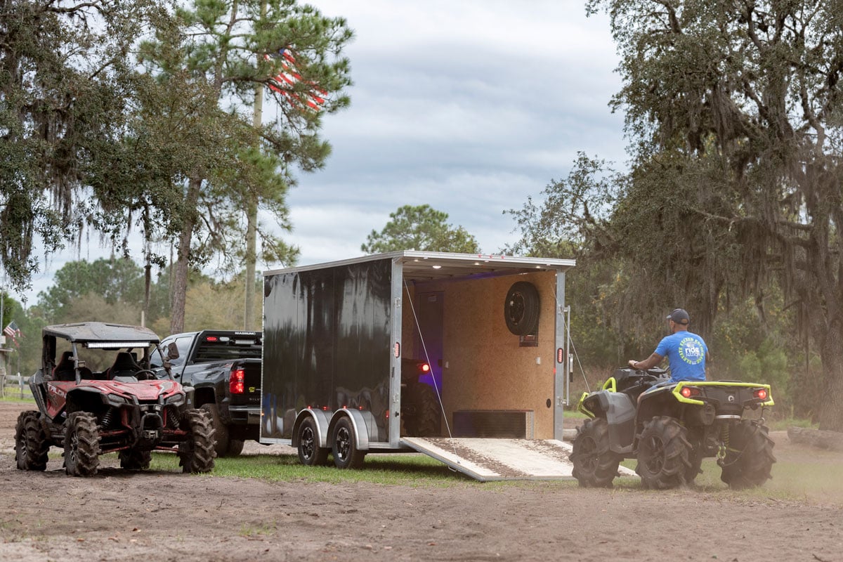 ATVs and UTVs loading up in an enclosed ALCOM aluminum trailer in Florida