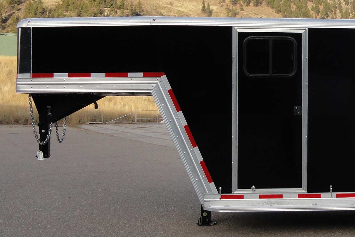 Gooseneck attic and side door shown on trailer parked in lot