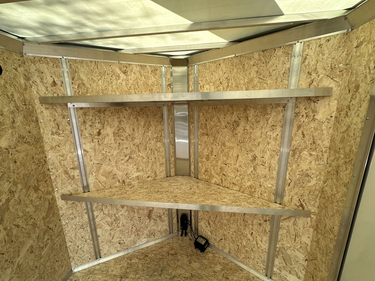 Integrated wall stud package in trailer V-nose, plus installed shelving for organization