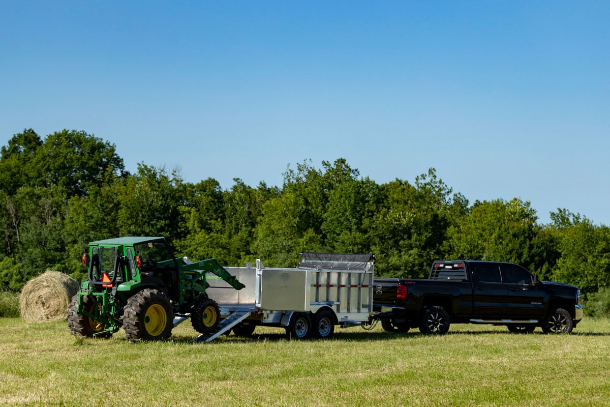 Loading a John Deere tractor into an ALCOM aluminum commercial dump trailer