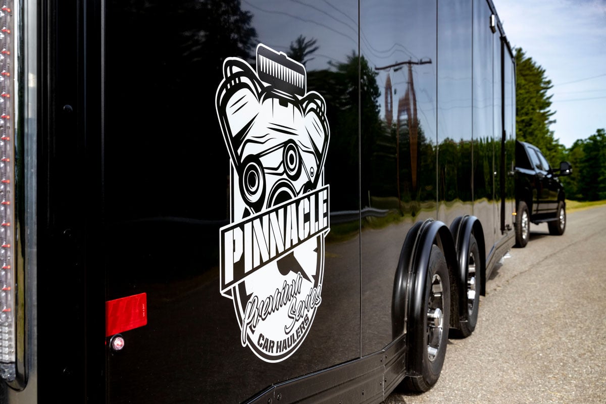 Black Mission Pinnacle Series enclosed racecar trailer on the road
