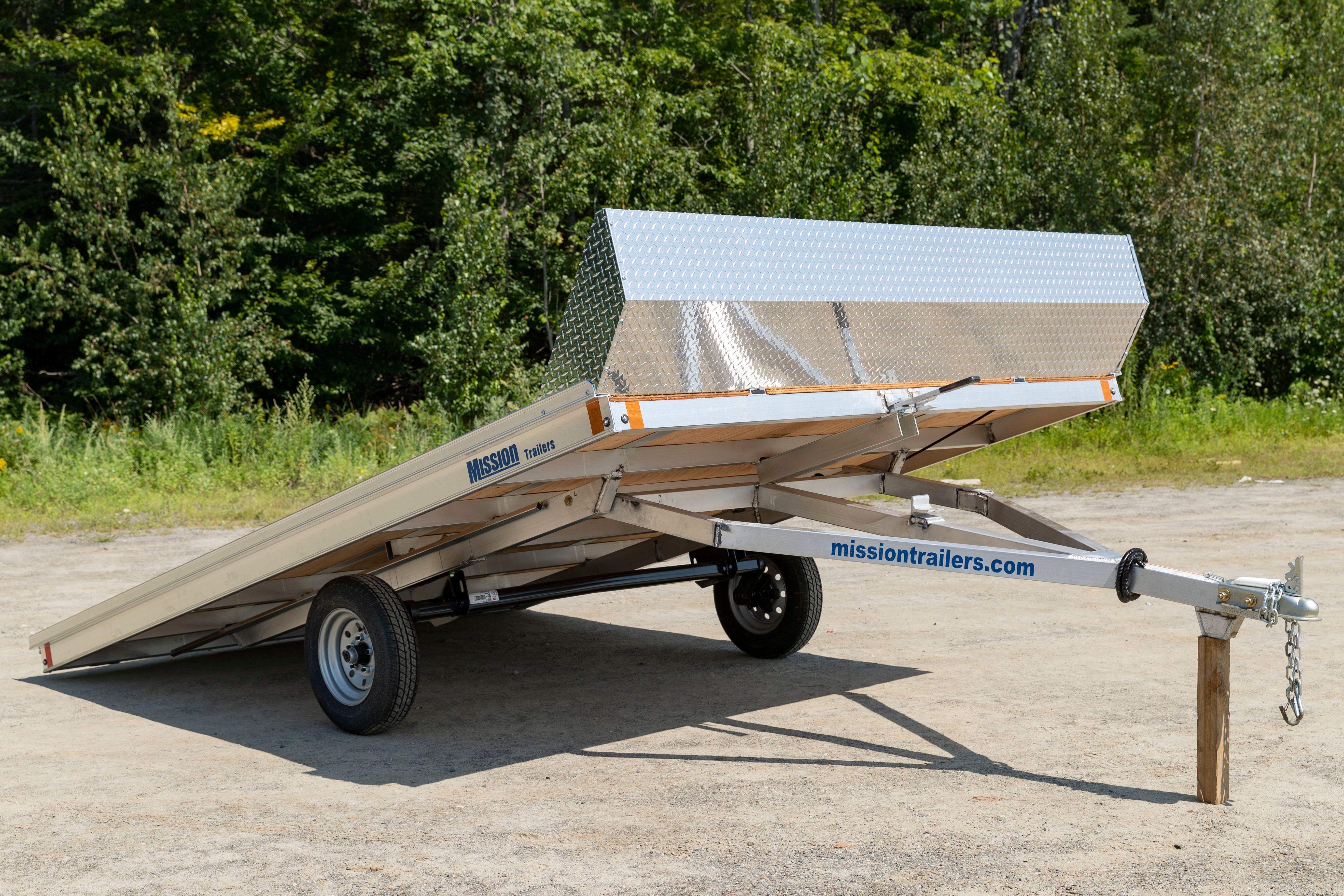 A Mission aluminum open tilting snowmobile trailer