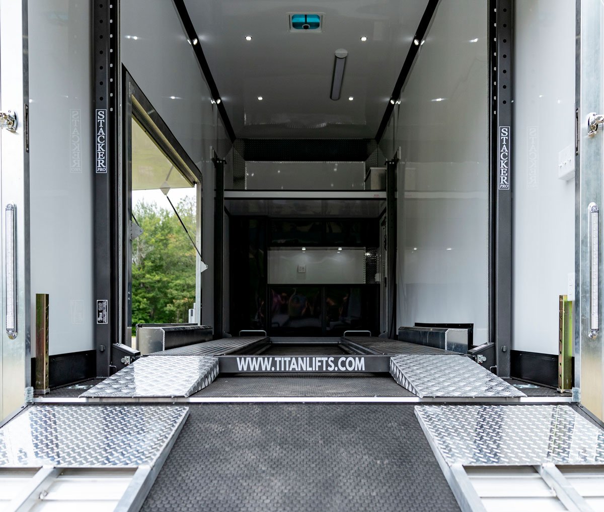 Pinnacle Stacker Series ramp door shown open with lift and loft visible inside trailer
