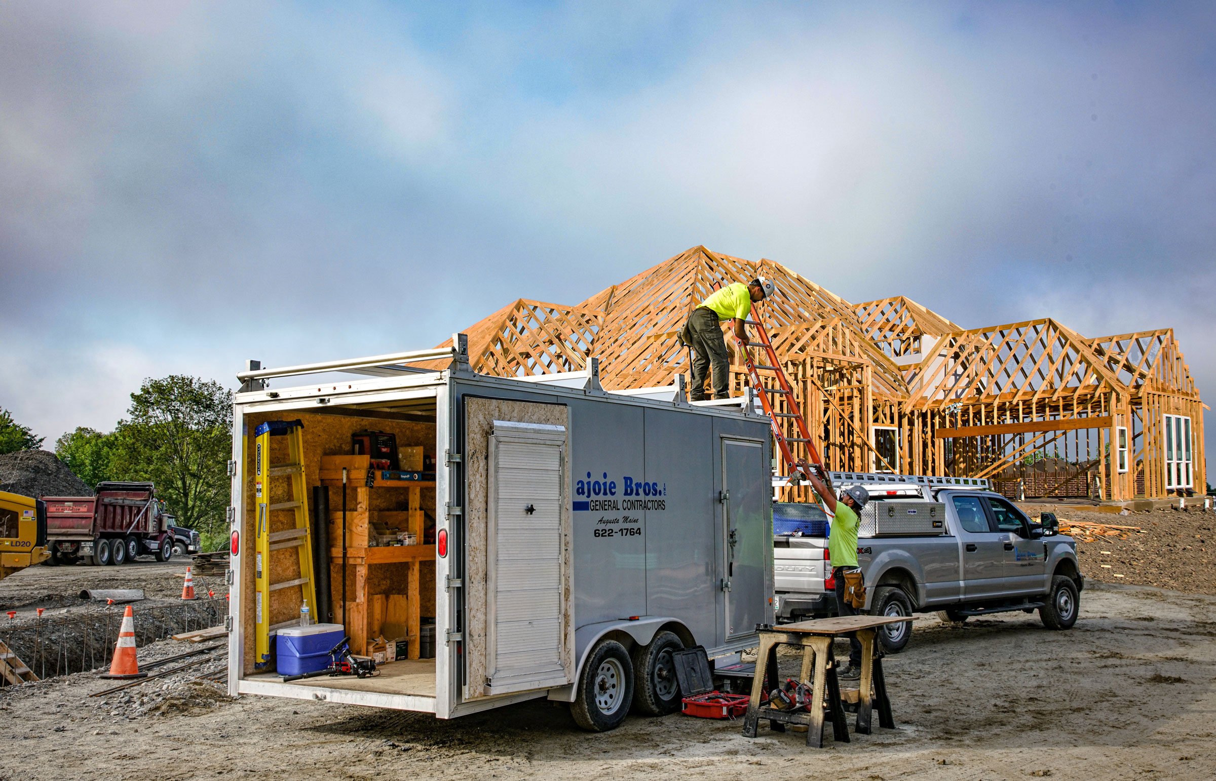 Construction trailer with ramp doors open showing custom built shelving
