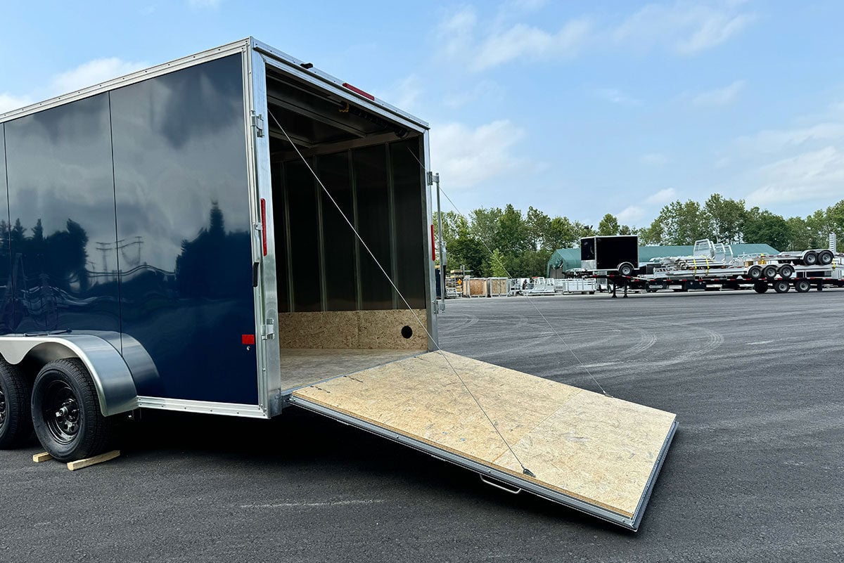 Side view of 7' Wide XLT Pro Cargo trailer with rear ramp door open