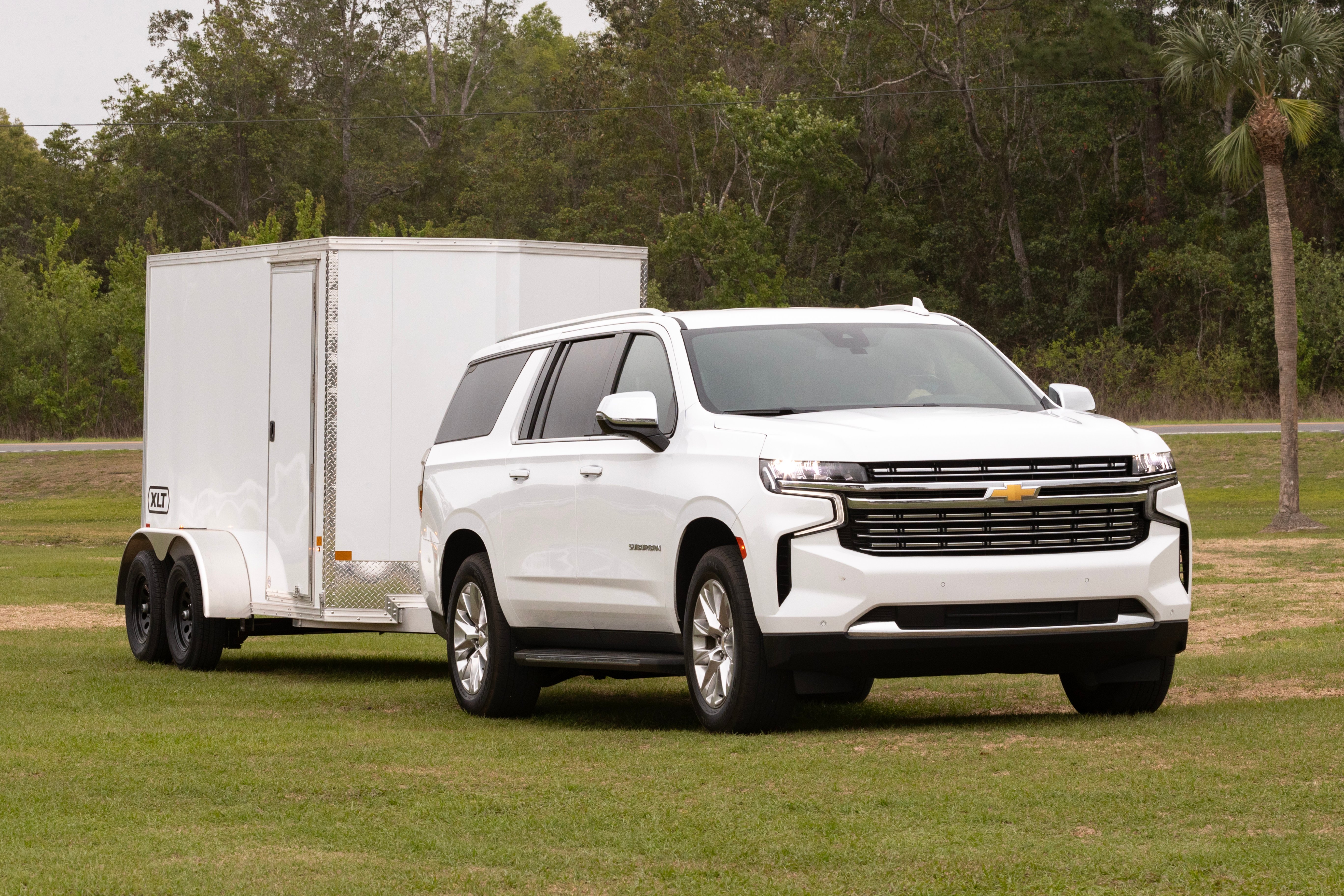 An XLT Pro Series enclosed cargo trailer towed by a white SUV