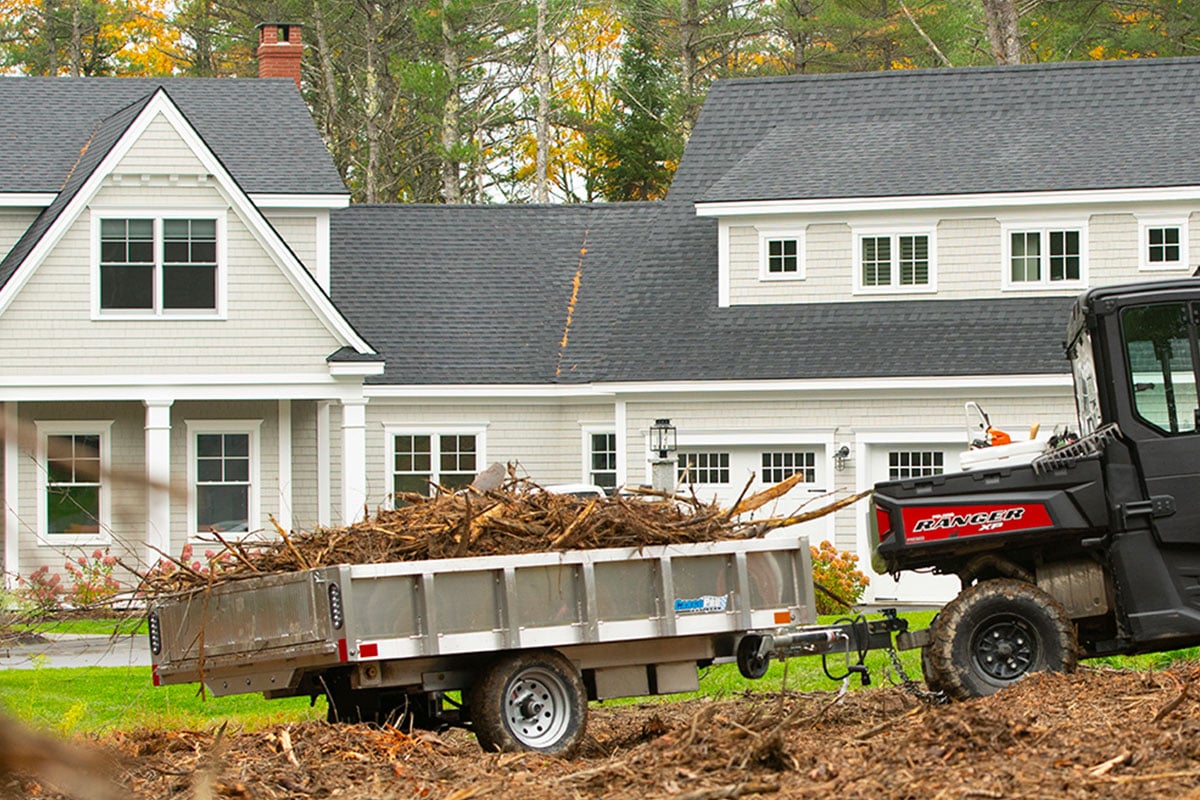 A well maintained homeowner dump trailer by ALCOM during yard cleanup