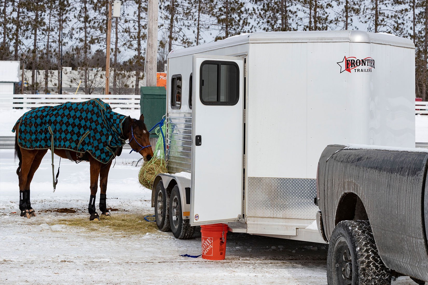 White bumper pull aluminum horse trailer by ALCOM with feed hooks