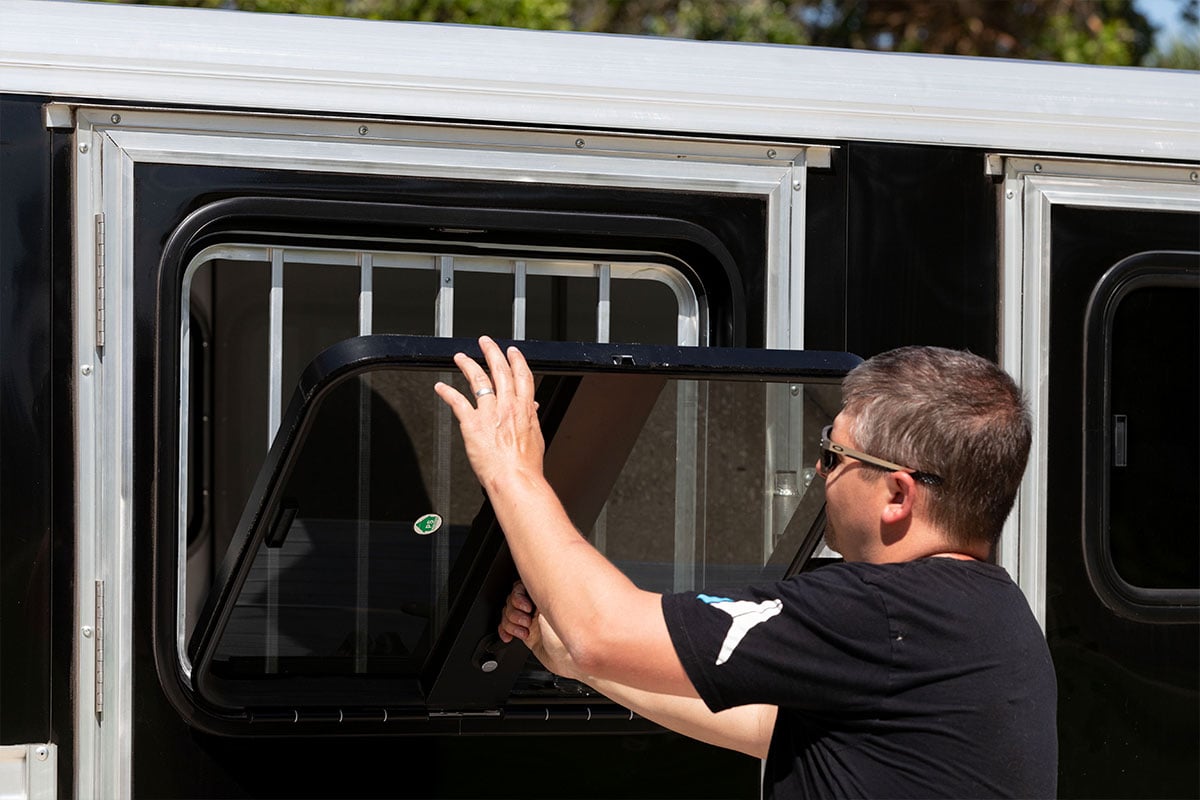 Drop-down feed windows with aluminum bars on a Frontier horse trailer