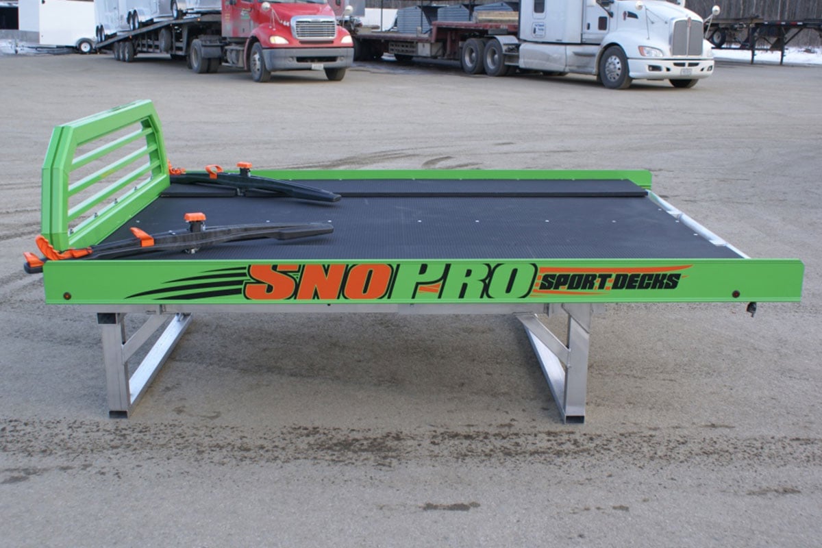 Full side view of a bright green all aluminum sport deck by SnoPro, an ALCOM brand